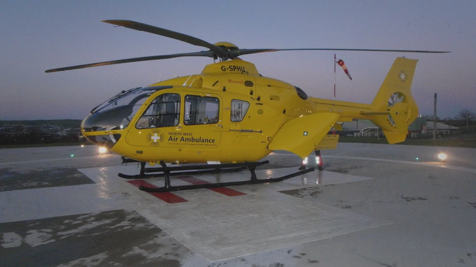 Air-ambulance helicopter on a hospital helipad at dusk