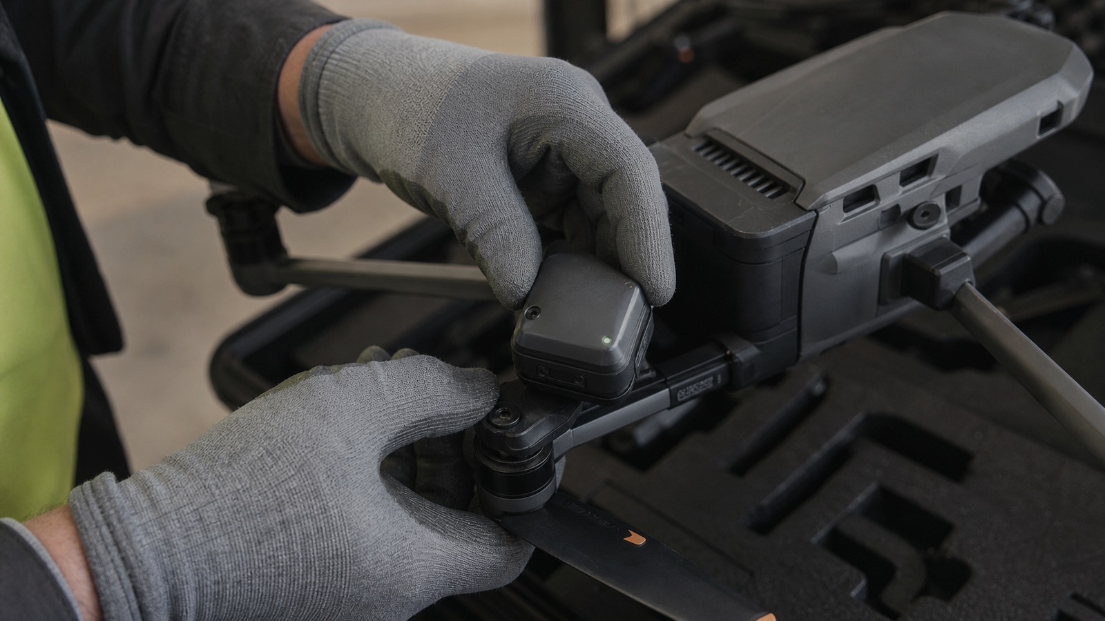 Rugged identity module being fitted to an existing commercial drone.